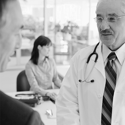 Physician speaking with a clinical research colleague