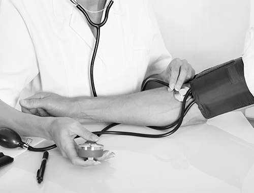 Clinician measuring blood pressure during a metabolic and cardiovascular study visit